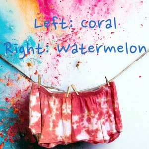 May include: Tie-dye shorts with a coral and watermelon design hanging on a clothesline against a colorful background. The text "Left: coral" and "Right: watermelon" is written above the shorts.