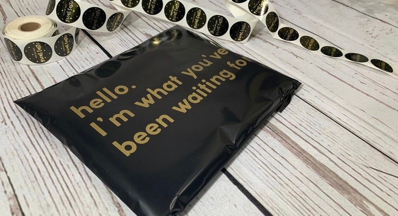 May include: Black poly mailer with gold text that reads "hello. i'm what you've been waiting for".