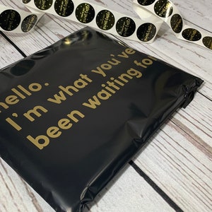 May include: Black poly mailer with gold lettering that reads "hello. i'm what you've been waiting for".