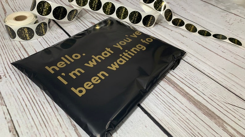 May include: Black poly mailer with gold lettering that reads "hello. i'm what you've been waiting for".