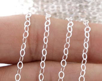 May include: Silver chain, a close-up of a silver chain, showing the links of the chain.