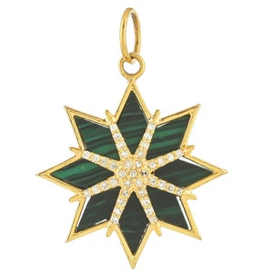 May include: A gold pendant in the shape of an eight-pointed star with a green malachite stone in the center and clear diamonds around the stone.