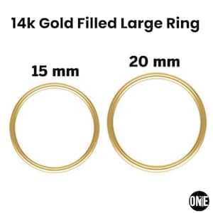 May include: Two gold-filled rings, one 15 mm and the other 20 mm in diameter, are displayed. The text "14k Gold Filled Large Ring" is at the top. The rings are circular and have a shiny, metallic appearance. The brand logo is in the bottom right corner.