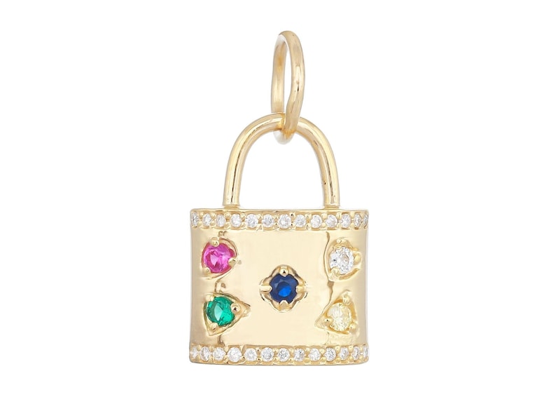 May include: A gold padlock charm featuring a row of small clear stones along the top and bottom edges. The center of the padlock is set with a blue stone, surrounded by four smaller stones in pink, green, white, and yellow, each in a bezel setting.
