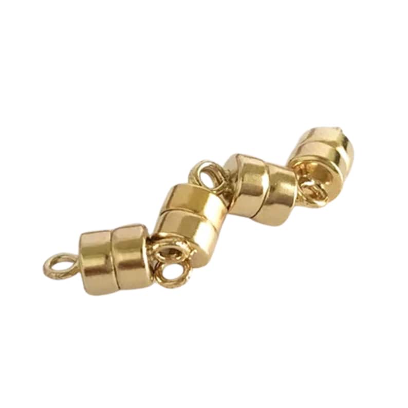 May include: A set of gold-colored magnetic jewelry clasps. Each clasp is cylindrical with a small loop on each end for attaching to jewelry. The clasps are arranged in a zig-zag pattern against a white background.