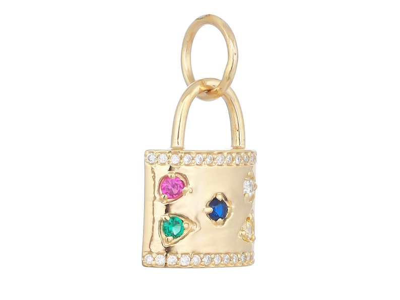 May include: A gold padlock charm featuring a row of small clear stones along the top and bottom edges. The center surface is decorated with a pink, a blue, and a green round gemstone, along with two additional clear stones on the right side.