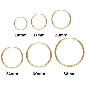 May include: Six gold hoop earrings in different sizes, ranging from 14mm to 38mm in diameter.