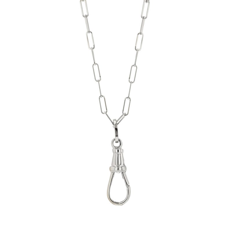 May include: A silver-colored necklace with a long, rectangular link chain and a decorative clasp. The clasp is a rounded, elongated shape with a hinged opening. The necklace hangs vertically against a white background.