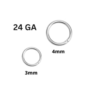 May include: Two silver jump rings, one 3mm and one 4mm, with the text "24 GA" above. These jewelry findings are used for crafting and jewelry making. The rings are open, ready to be connected.