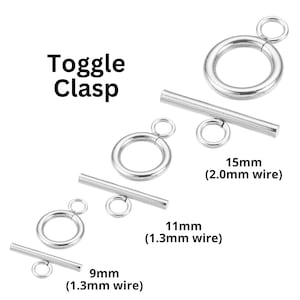 May include: Silver toggle clasps in three sizes: 9mm, 11mm, and 15mm. The clasps are made of metal wire and have a smooth, polished finish. The 9mm and 11mm clasps are made with 1.3mm wire, while the 15mm clasp is made with 2.0mm wire.