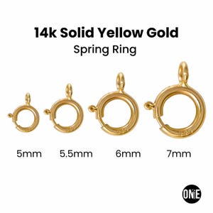 May include: Four 14k solid yellow gold spring rings in varying sizes: 5mm, 5.5mm, 6mm, and 7mm. Each ring features a circular design with a spring mechanism for secure closure. The image displays the rings in an open position.