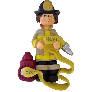 May include: A personalized Christmas ornament featuring a female firefighter holding a yellow fire hose. The ornament is decorated with a red fire hydrant and the words "Name" and "Year".