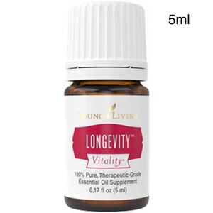 May include: A small brown glass bottle with a white cap, labeled "LONGEVITY Vitality" in red and white. The label also states "100% Pure, Therapeutic-Grade Essential Oil Supplement" and "0.17 fl oz (5 ml)". The bottle is 5 ml in size.