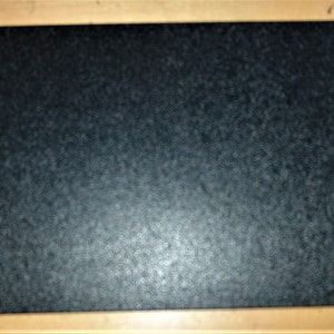 May include: A black cutting board with a textured surface.