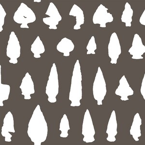 May include: A repeating pattern of white arrowhead silhouettes on a dark gray background. The arrowheads vary in shape and size, creating a textured, graphic design. This pattern is suitable for fabric, wallpaper, or digital art.