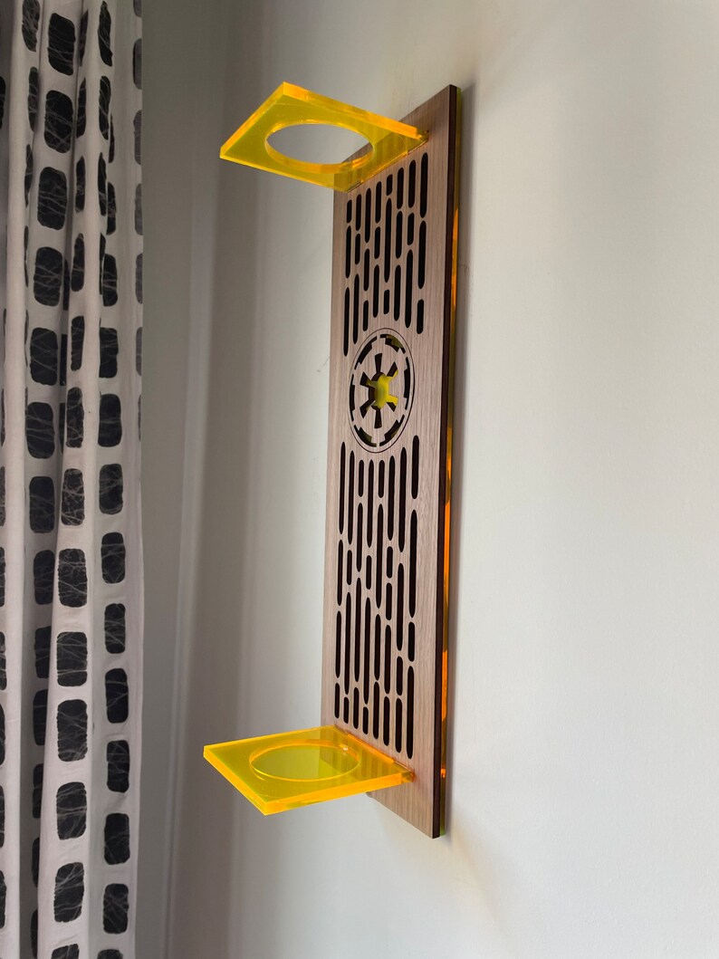 May include: A wooden wall shelf with a Star Wars Imperial symbol and two yellow acrylic shelves.