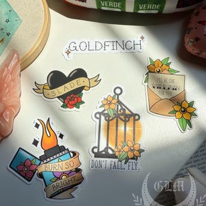 Plated Prisoner Sticker | Slade Ravinger | Plated Prisoner Series | Plated Prisoner Merch | Goldfinch | Gild Glint Gleam Glow Gold | Auren