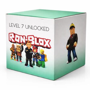 May include: A square box with a light green top and sides. The box features the text "LEVEL 7 UNLOCKED" above the red and white "RON-BLOX" logo. Cartoon characters are displayed on the front and side of the box.