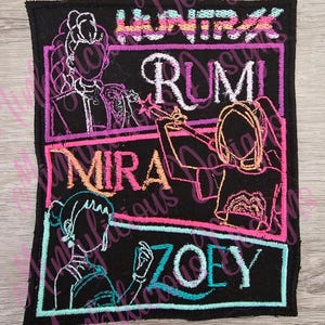 May include: Black embroidered patch featuring four names: Huntrix, Rumi, Mira, and Zoey, each within a colored rectangular frame. The names are in white, teal, and pink. The patch has a black border and stylized illustrations of women.