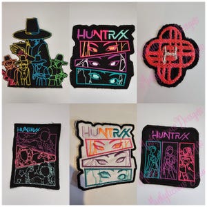 May include: A selection of embroidered patches with diverse designs. One patch depicts figures in hats, another shows the text "HUNTRX" above stacked eye designs, and a third has a red and black clover shape with the letter "H".