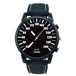 May include: Black wristwatch with a black band and a white speedometer-style face that reads "km/h ELECTRONIC".