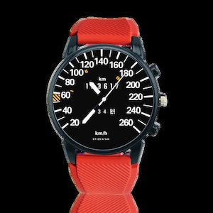 May include: A black wristwatch with a speedometer-style face, featuring white numerals against a black background. The watch has a red silicone band and a black case. The face displays km/h and the text "C1123 07149".