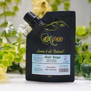 May include: A black pouch with a black spout, containing hair care product. The pouch has the text "Eko" in yellow and green, and "Hair Keya" in blue. The text "Loving it all Natural!" is also visible.