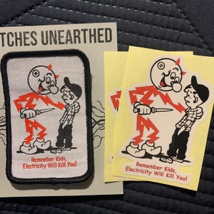 May include: A red and white patch with a cartoon character holding a knife and the text "Remember Kids, Electricity Will Kill You!" Two yellow stickers with the same image and text are also shown.
