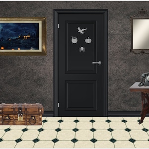 May include: A black door with a Halloween theme. The door has a cauldron, pumpkin, spider, and bird cutouts. There is a wooden chest with a lock, a framed picture, a mirror, and a vintage phone on a table.