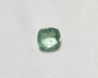 May include: A light green emerald gemstone with a cushion cut.