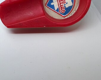 May include: Red plastic ashtray with a white and blue Phillies logo in the center.