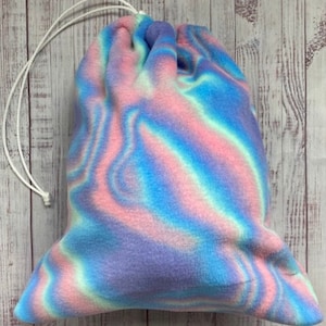 May include: A drawstring bag made of soft, blue, pink, and white fleece with a swirling tie-dye pattern.