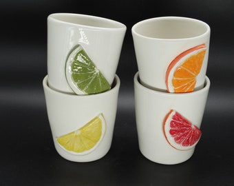 Set 4 ceramic glasses with citrus slices white ceramic glasses  with slices of orange lemon claim or sanguine