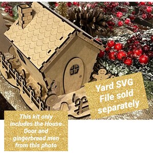 May include: A wooden gingerbread house kit with a brown roof, white trim, and a gingerbread man figurine. The kit includes the house, door, and gingerbread men. The text "Yard SVG File sold separately" is on a gold glitter background.