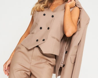 May include: A brown sleeveless blazer with a double-breasted closure and a matching pair of pants.