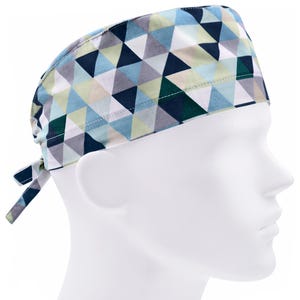 May include: A blue, green, and white patterned surgical scrub hat with a tie at the back.