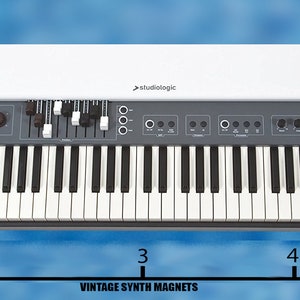 May include: A white and gray Studiologic Numa Organ with a wooden side panel. The keyboard has 61 keys and the text "Studiologic" and "Numa Organ" is printed on the front panel. The organ is 5 inches wide.