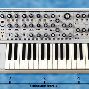 May include: A silver analog synthesizer with a 37-key keyboard, a control panel with knobs and buttons, and the text "SUB 37 CV".