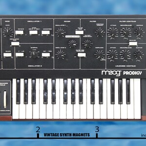 May include: A black Moog Prodigy analog synthesizer with a 37-key keyboard, knobs, and sliders. The synthesizer is 3 inches wide.