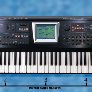 May include: Black Roland V-Synth keyboard with a digital display and a variety of knobs and buttons. The keyboard is 4 inches wide.