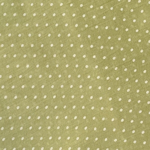 May include: A sage green fabric featuring a repeating pattern of small, white, circular polka dots. The material has a visible, fine-textured weave with a consistent, evenly spaced arrangement of dots across the entire surface of the textile.