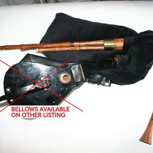 May include: A black leather bag with a brown wooden pipe and a black leather strap. The text "BELLOWS AVAILABLE ON OTHER LISTING" is written in red across the image.