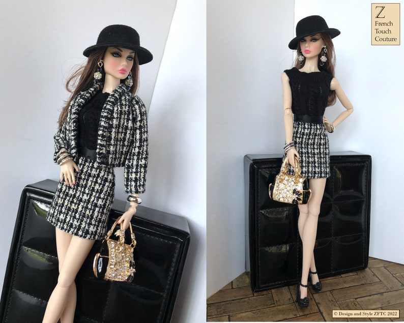 May include: A black and white checkered skirt and jacket set with a black top, black hat, and gold handbag. The doll is wearing black earrings and bracelets.