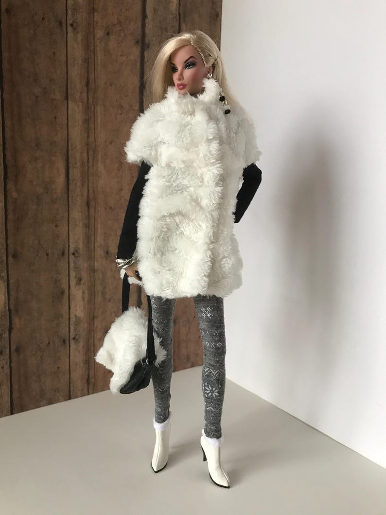 May include: A white faux fur vest with black trim and buttons, worn with gray snowflake patterned tights and white boots.
