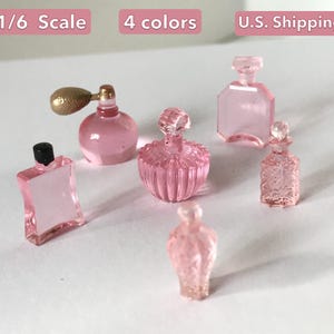 May include: A selection of miniature pink perfume bottles in diverse shapes and designs. One bottle has a gold-coloured atomizer, while others feature decorative stoppers. The image includes text that says "1/6 Scale" and "4 colours".