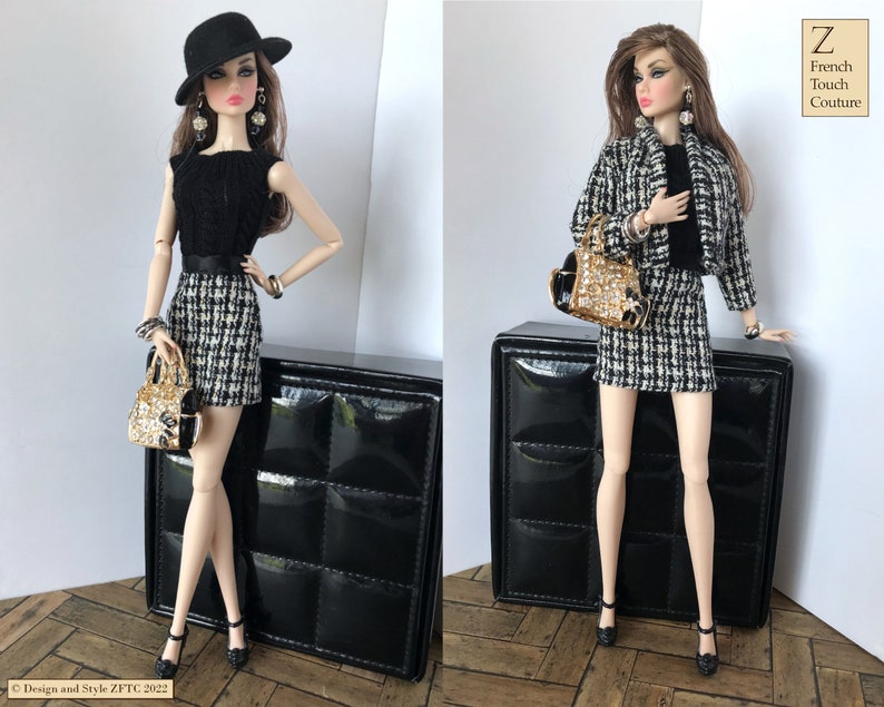 May include: A fashion doll wearing a black and white checkered skirt and a black top with a black hat. The doll is holding a gold and black handbag. The doll is standing on a black surface. The image includes the text "Z French Touch Couture".