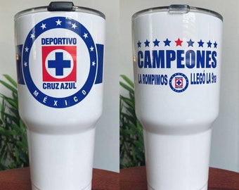 May include: White stainless steel tumbler with a blue and red logo that says "Deportivo Cruz Azul Mexico" and a blue and white logo that says "Campeones La Rompimos Llego La 9na".