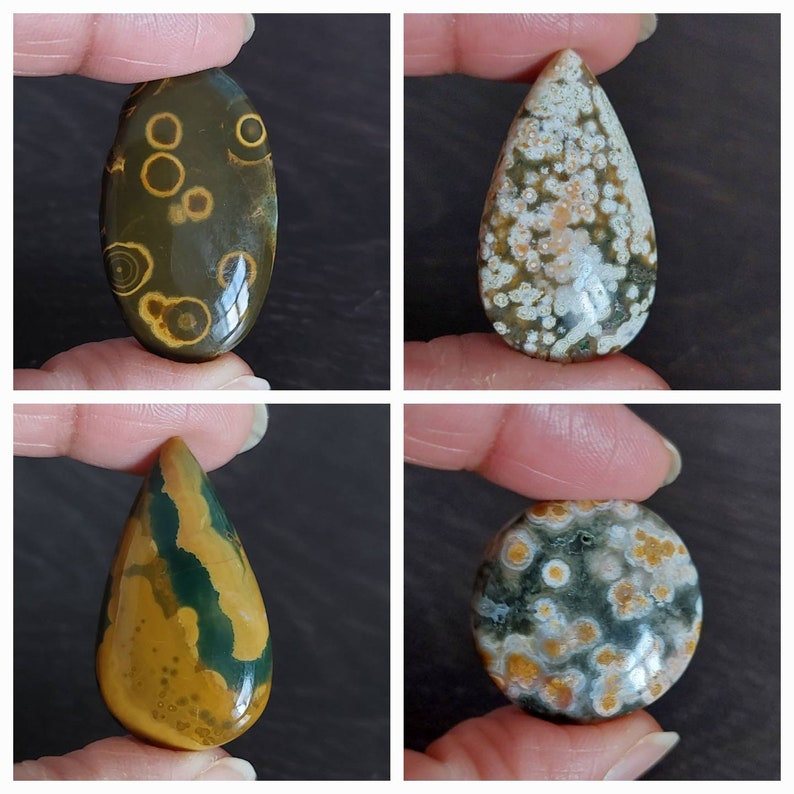 May include: Four different ocean jasper cabochons in various shapes and colors. The cabochons are a mix of brown, green, white, and orange.