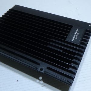 May include: Black Harman Kardon LOGIC 7 amplifier with a metal grill and a black label.