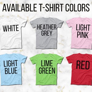 May include: Six t-shirts in different colours, showing the available colours for purchase. The colours are white, heather grey, light pink, light blue, lime green, and red.
